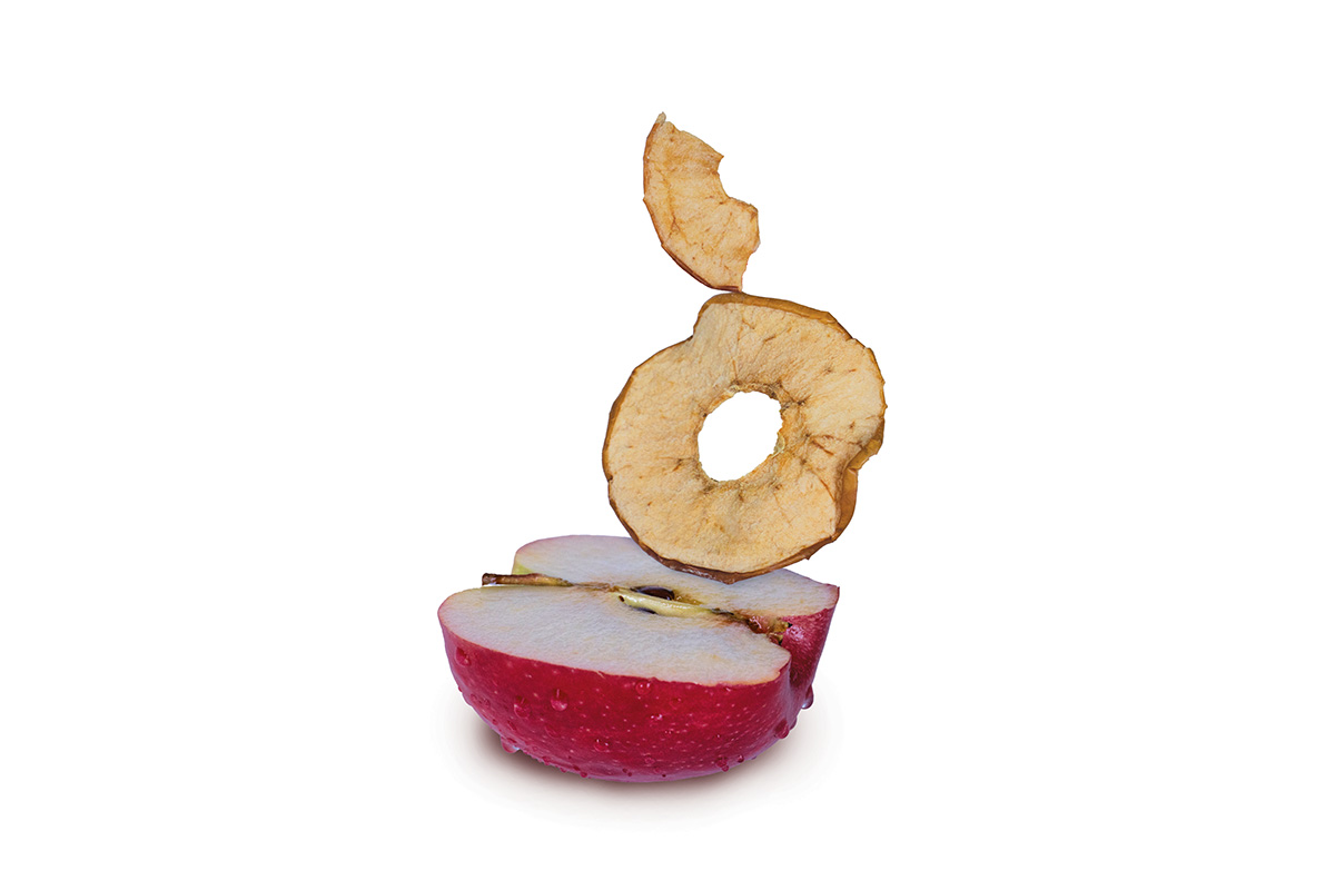 apple chips balancing on half an apple